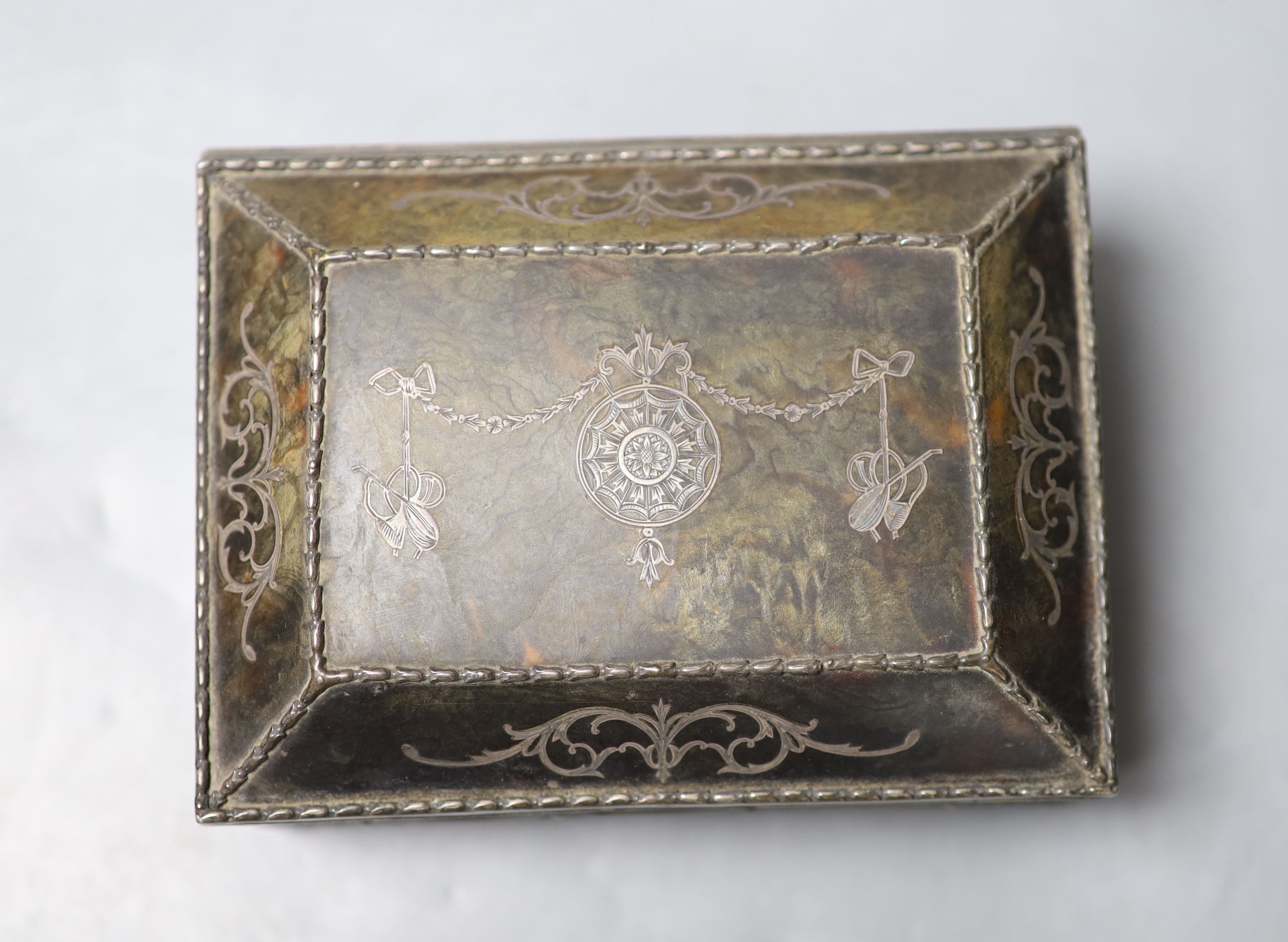 A silver-mounted tortoiseshell pique rectangular trinket box, by William Comyns, raised on four ball feet, London, 1904, width 15cm. 15cm